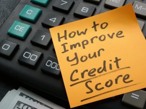 A Memo stick with How to improve your credit score inscription on the calculator.